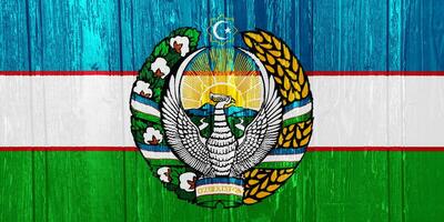 bandeira e casaco do braços do república do uzbequistão em uma texturizado fundo. conceito colagem. foto