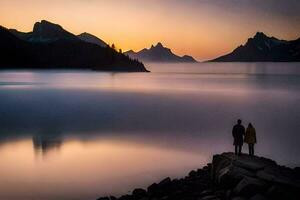 dois pessoas ficar de pé em uma Rocha negligenciar uma lago às pôr do sol. gerado por IA foto