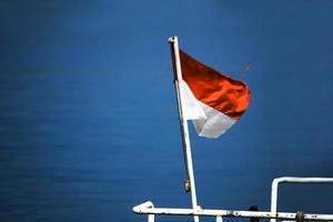 bandeira nacional da indonésia balançando no mar azul foto