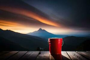 uma vermelho balde em uma de madeira mesa com montanhas dentro a fundo. gerado por IA foto