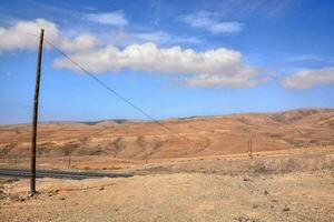 uma Telefone pólo dentro a deserto com montanhas dentro a fundo foto