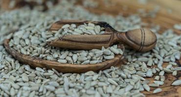 sementes de girassol em madeira de oliveira