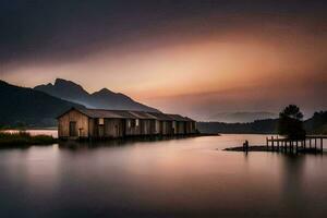 uma lago casa dentro a montanhas às pôr do sol. gerado por IA foto