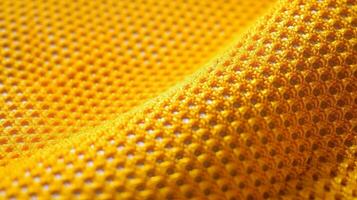 amarelo futebol tecido textura com ar malha. Atlético vestem pano de fundo foto
