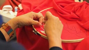 bordar costurando à mão de mulher. trabalhos manuais e mãos femininas. foto