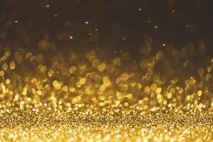 fundo de luzes brilhantes de glitter dourados foto