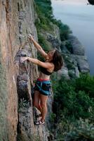 uma menina sobe uma Rocha. mulher acionado dentro extremo esporte. foto