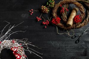 faço uma Natal guirlanda com seu próprio mãos. local de trabalho para preparando feito à mão decorações. foto