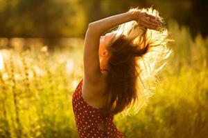 mulher com o cabelo ao sol da tarde foto