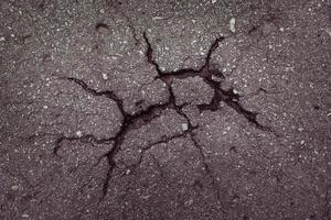 asfalto com rachaduras na superfície foto
