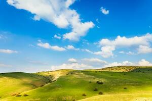 suíço panorama tema fundo com verde Campos e lindo céu foto