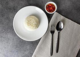 arroz de jasmim servir em um prato com colher e garfo em restaurante foto