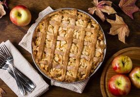 torta de maçã de ação de graças com talheres e folhas de outono foto