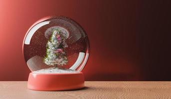 globo de neve mágico com árvore de natal na mesa de madeira foto