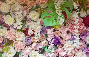 floral fundo. muitos do artificial flores dentro colorida composição em feito à mão de madeira Rosa fundo foto
