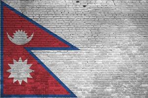 Nepal bandeira retratado dentro pintura cores em velho tijolo muro. texturizado bandeira em grande tijolo parede alvenaria fundo foto