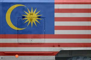 Malásia bandeira retratado em lado parte do militares blindado caminhão fechar-se. exército forças conceptual fundo foto