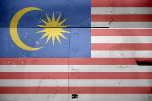 Malásia bandeira retratado em lado parte do militares blindado helicóptero fechar-se. exército forças aeronave conceptual fundo foto