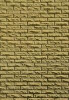 textura da parede de tijolos de pedras de relevo sob a luz do sol foto