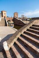 Comacchio , Itália-junho 2, 2023-pessoas passear dentro Comacchio dentro frente fora a famoso três pontes durante uma ensolarado dia foto