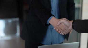 close-up de empresários apertando as mãos, terminando reunião, etiqueta empresarial, parabéns, conceito de fusão e aquisição foto