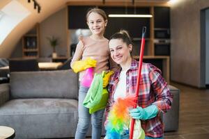 feliz mãe e filha limpeza casa juntos foto