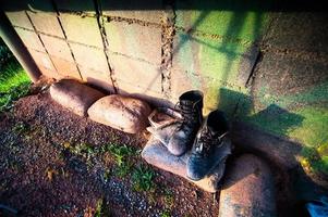 botas militares de couro preto velhas e sujas foto