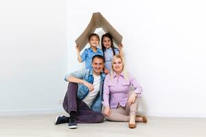 feliz família jogando para dentro Novo lar. pai, mãe e criança tendo Diversão junto. comovente casa dia e real Estado conceito foto