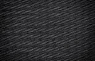 fundo de textura de seda de lona de tecido preto. Detalhe abstrato do close up do papel de parede de material têxtil foto