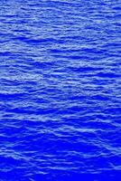 a oceano é azul e tem pequeno ondulações foto