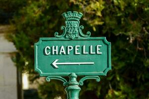 uma verde rua placa apontando para a direção do chapelle foto