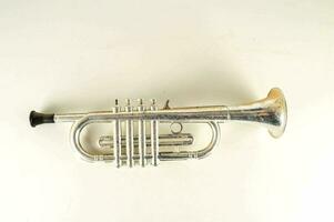 uma prata trompete em uma branco fundo foto