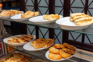 pratos com vários pastelaria dentro a cantina foto