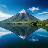 ai gerado captura a sereno beleza do uma vulcânico montanha refletido dentro uma calma, claro como cristal lago foto