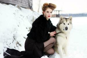 jovem mulher com Lobo cachorro dentro neve foto