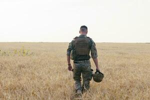 soldado homem em pé contra uma campo foto