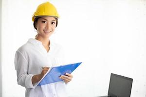 mulheres asiáticas engenharia, inspecionando, trabalhando e segurando plantas no escritório foto