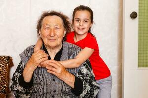 alegre jovem menina levando Cuidado do a idosos mulher às casa foto