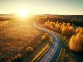 ai gerado aéreo Visão do montanha estrada dentro floresta às pôr do sol dentro outono foto