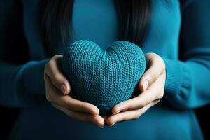 ai gerado mulher segurando azul tricotado coração dentro dela mãos foto