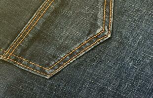textura abstrata detalhada de pano jeans azul escuro. imagem de fundo de tecido de calça jeans usado velho foto