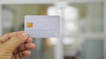 close-up da mão mostrando o cartão de crédito. foto