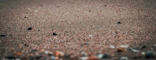 fechar acima areia de praia fundo conceito foto. colorida pequeno mar pedras em a de praia. foto