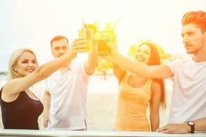 amigos tendo Diversão às a Barra ao ar livre, bebendo coquetéis. foto