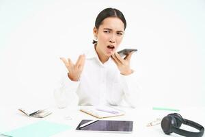 retrato do Bravo coreano empregador, senhora patrão senta dentro escritório com Móvel telefone, gritos com irritado face às celular, tem argumento, branco fundo foto