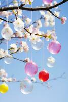 ai gerado uma deslumbrante foto do uma florescendo cereja Flor árvore com colorida Páscoa ovos suspensão a partir de Está galhos