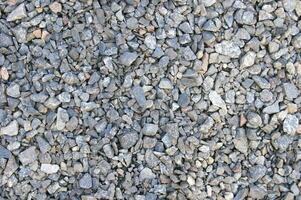 pequeno estrada pedra fundo, Sombrio cascalho pedrinhas pedra textura desatado textura foto