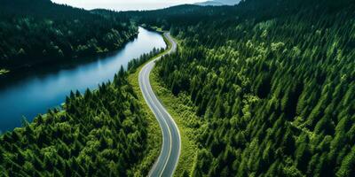 ai gerado aéreo Visão do uma estrada enrolamento através uma denso floresta e corrida ao lado uma lago foto