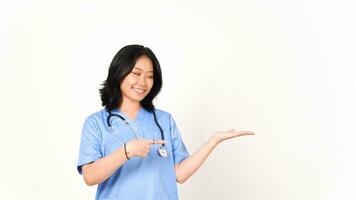 jovem ásia fêmea médico apontando cópia de espaço em Palma mão isolado em branco fundo foto
