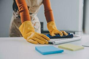 escritório limpeza serviço. zelador pulverização escrivaninha. local de trabalho higiene foto